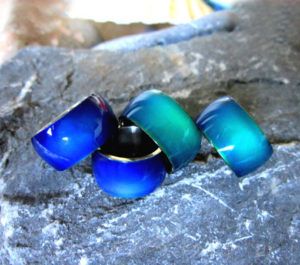 Graças a elementos termocromáticos como o cristal líquido, anéis de humor mudam de cor quando tocados. (Imagem: bestmoodrings.com)