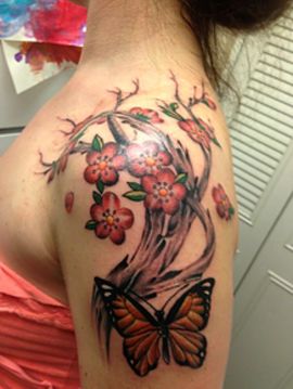 cherry blossom tattoo on shoulder and arm