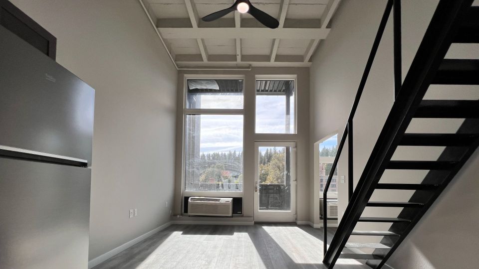 13'8" ceiling with ceiling fan in living room of loft floor plan.
