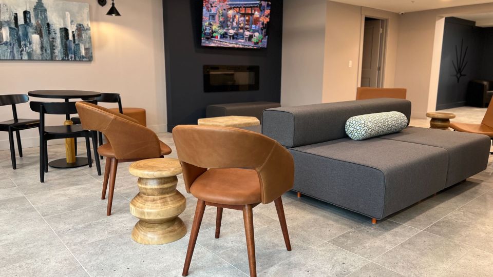 Large lounge with modern sectional couches, wet bar, and tall windows.