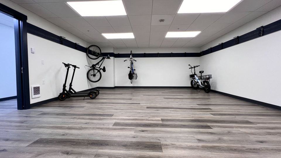 Two levels of bikes locked to indoor racks.