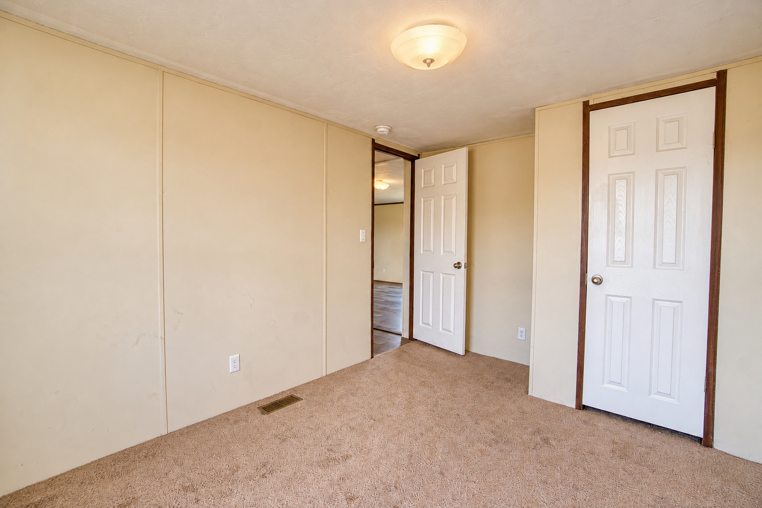 Bedroom showing closet and entry door - 215 Cale Lane, Calera OK