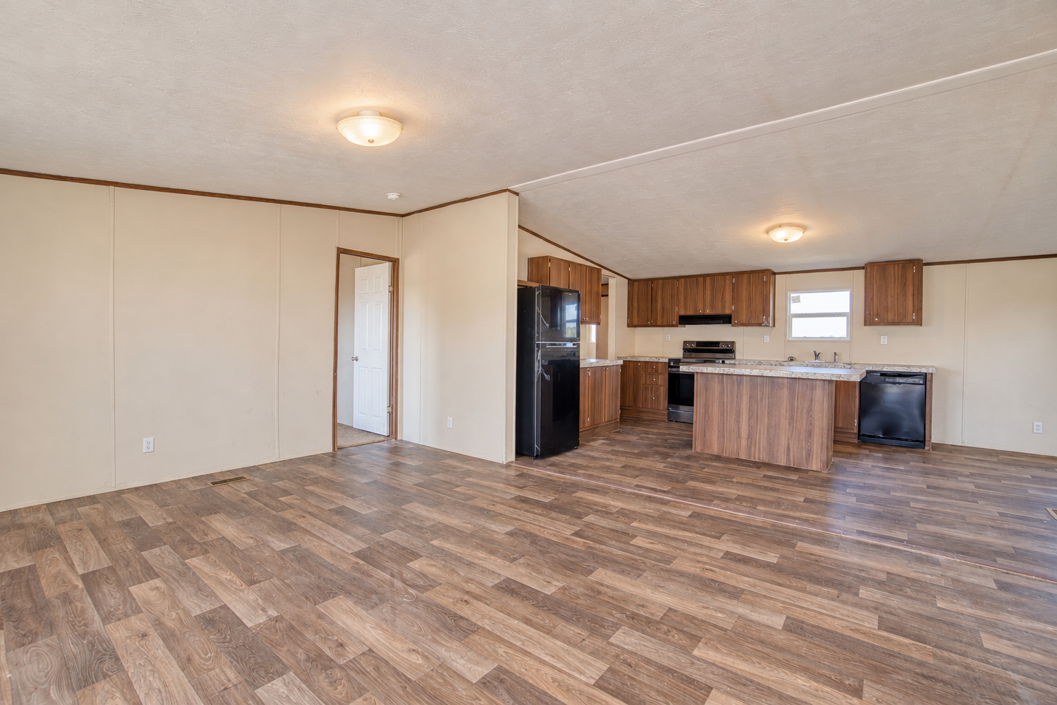 Open-concept living, dining and kitchen - 215 Cale Lane, Calera OK