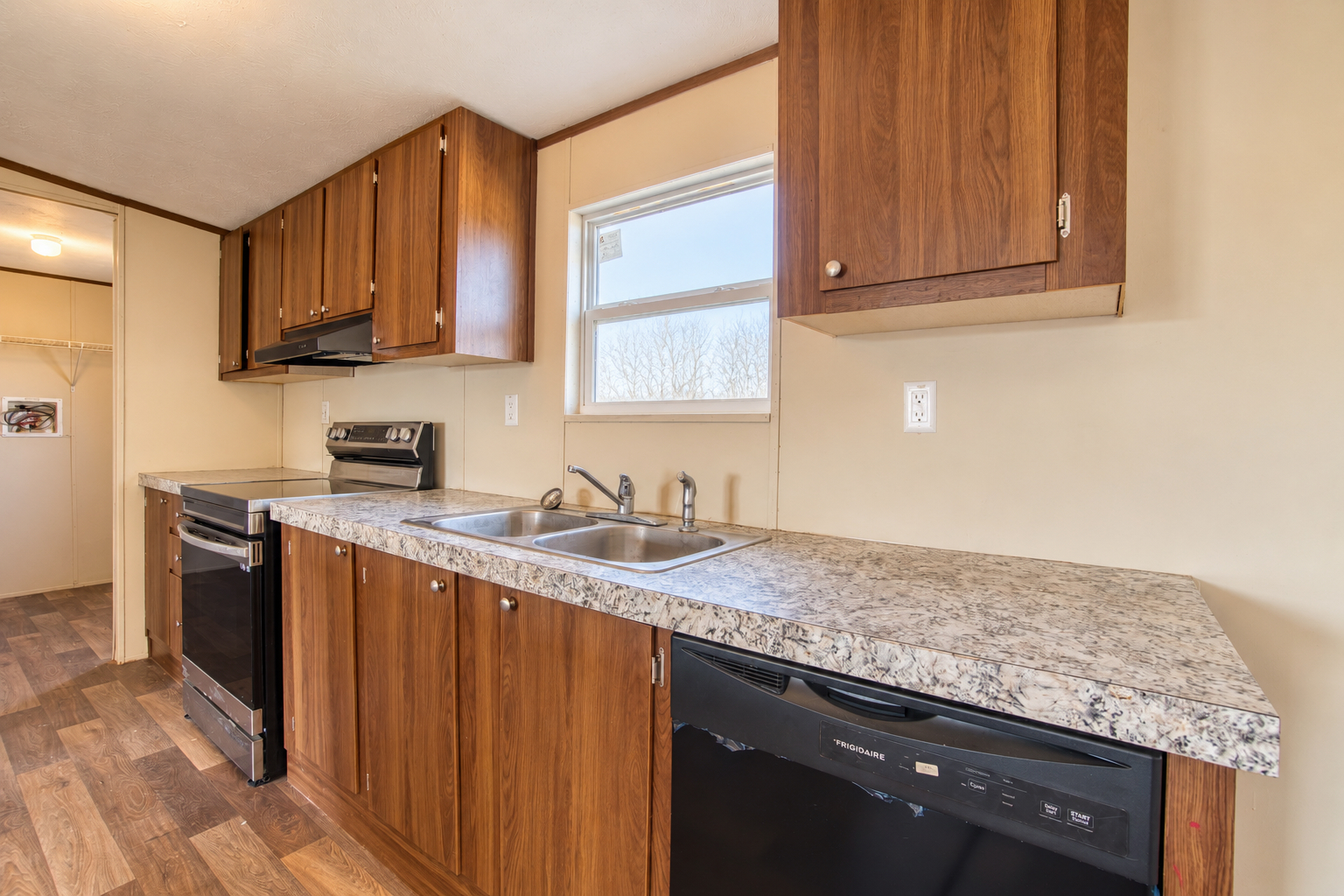 Kitchen sink under window with dishwasher - 215 Cale Lane, Calera OK