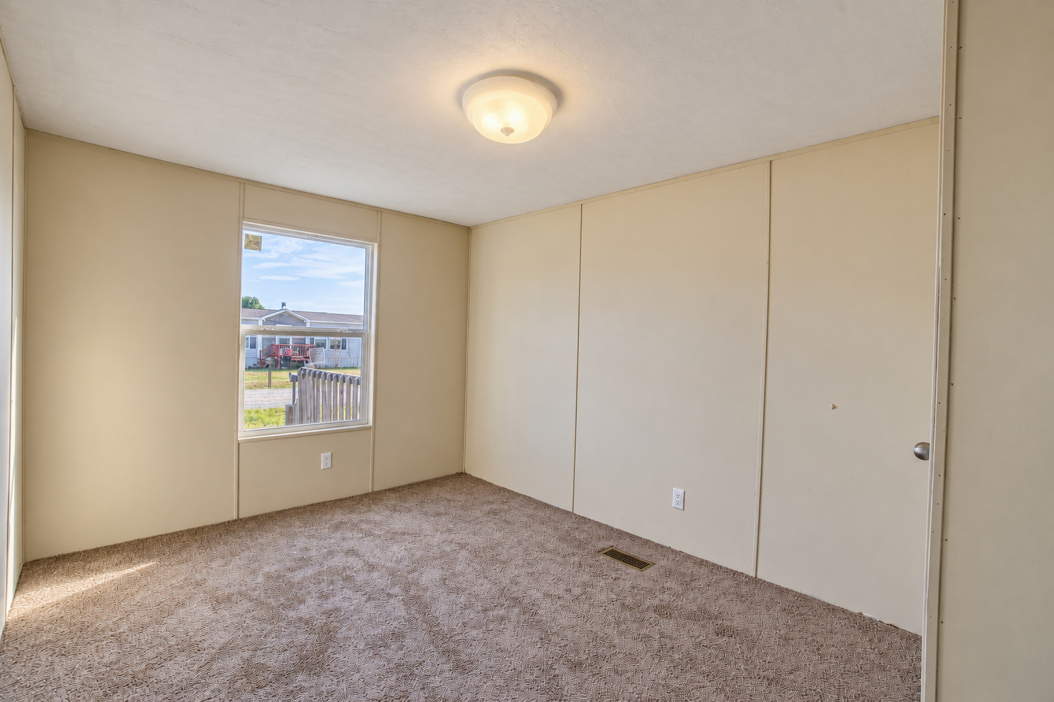 Bedroom with carpet and window - 215 Cale Lane, Calera OK