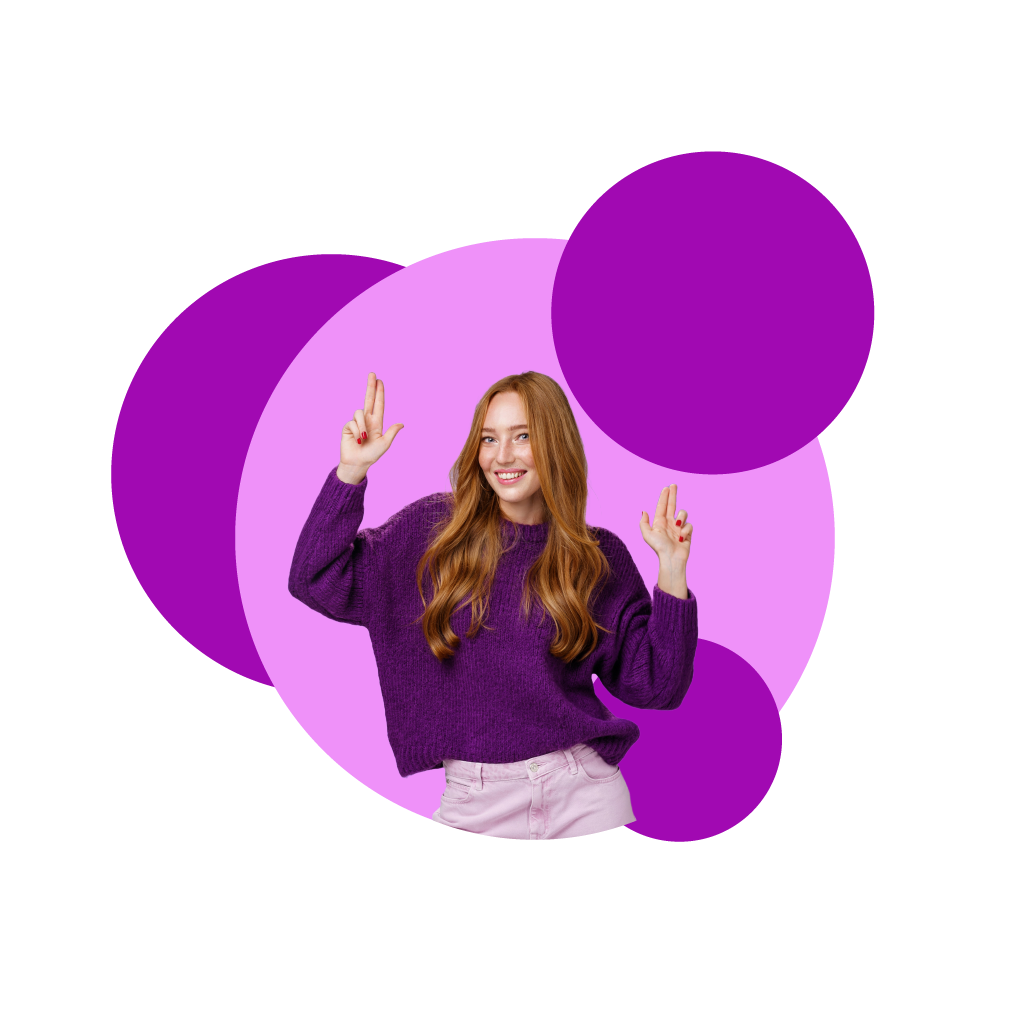 Woman with red hair with a dark purple jumper with light purple jeans, with purple spots behind her.