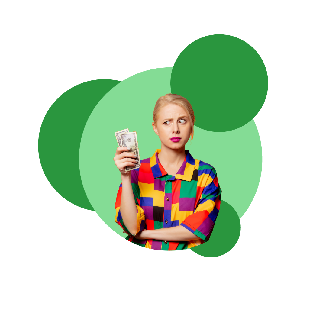 Blonde woman holding two notes of money, wearing a button up shirt with colourful squares or yellow, red, green, blue and black. with one arm tucked under the arm holding the money while looking at the money confused. With green spots behind her.