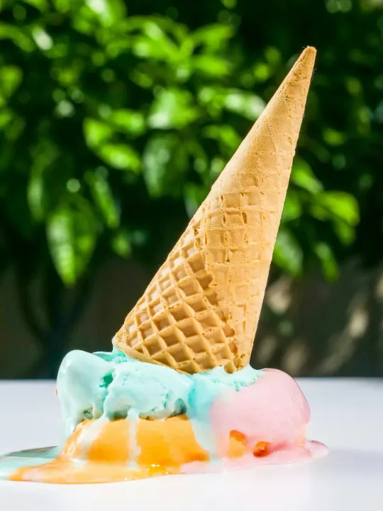 An ice cream cone melting on the counter