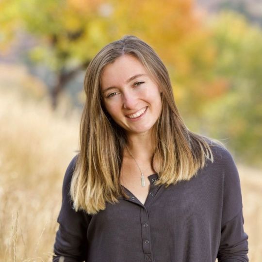 Kenzie M, Operations Manager and Coach at Coaching Academics, smiling outside