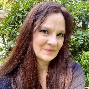 Liz, CEO, smiling at the camera