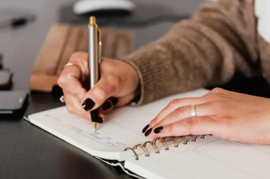 A calm study moment with a student writing in a notebook.