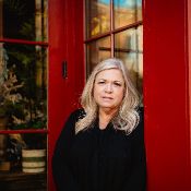 Amy, Executive Function Coach at Thrive Beyond Therapy smiling outside at the beach