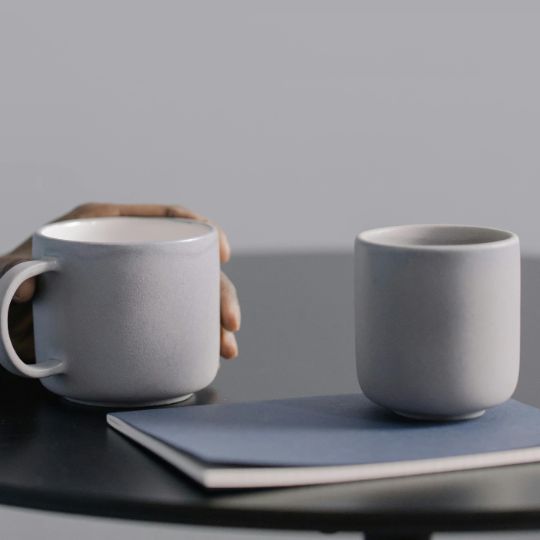 Close up of hands holding a heart shaped rock with hope carved in the front.