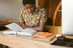 Student intently reading a text book
