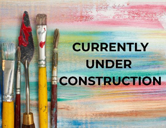 Clean paint brushes in a jar on a pale grey background