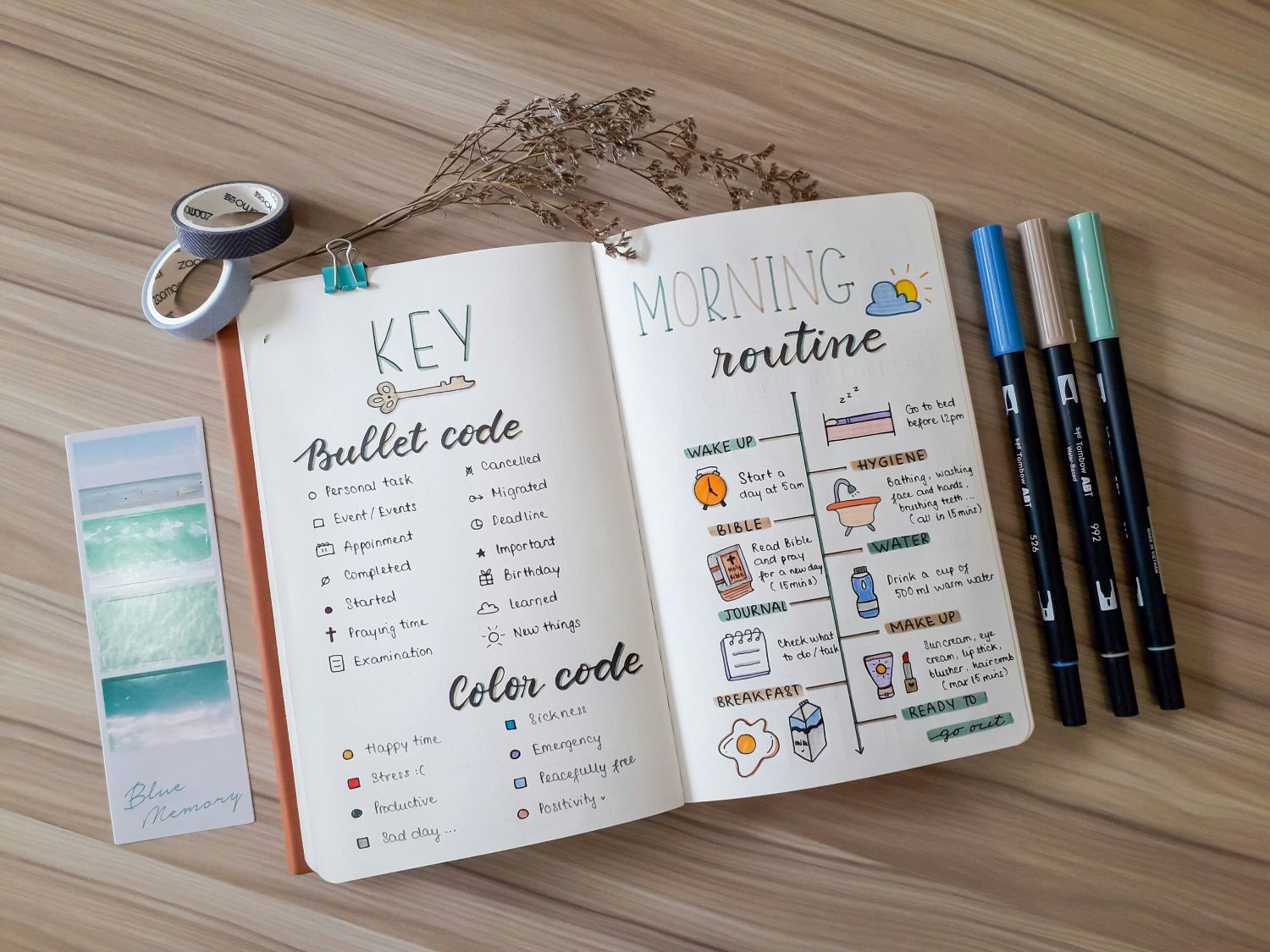 Open planner and colored markers with creative, fun notes and drawn pictures of a daily routine