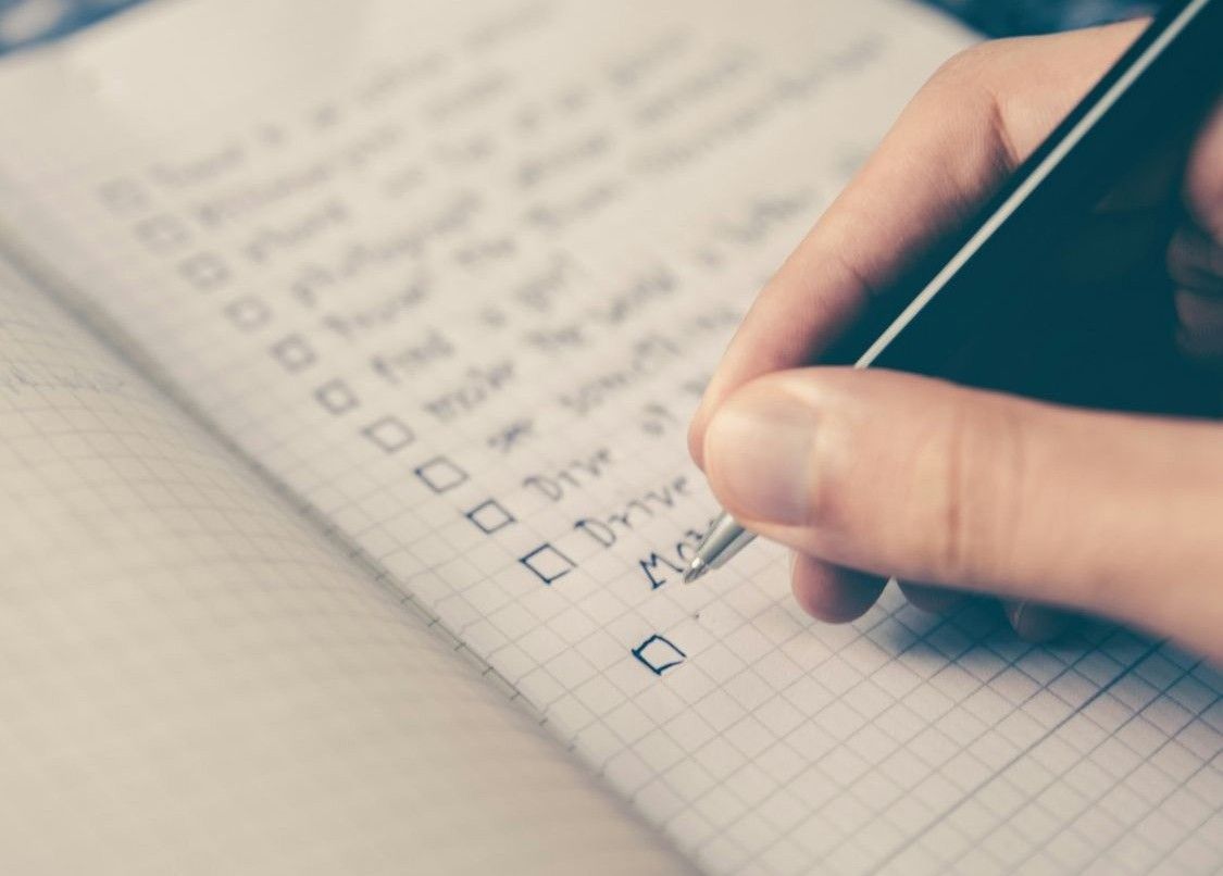 Hand poised to check off a box on a to-do list