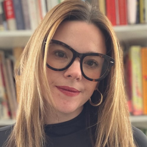 Portrait of Kenzie G, smiling and friendly standing outside