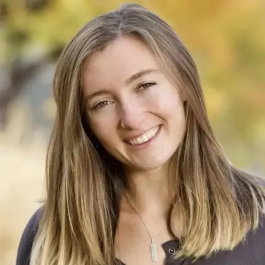 Portrait of Kenzie G, smiling and friendly standing outside