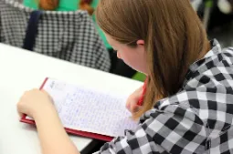 Student taking detailed study notes.