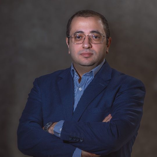 Service Delivery Manager at Reyada in a formal blue suit portrait